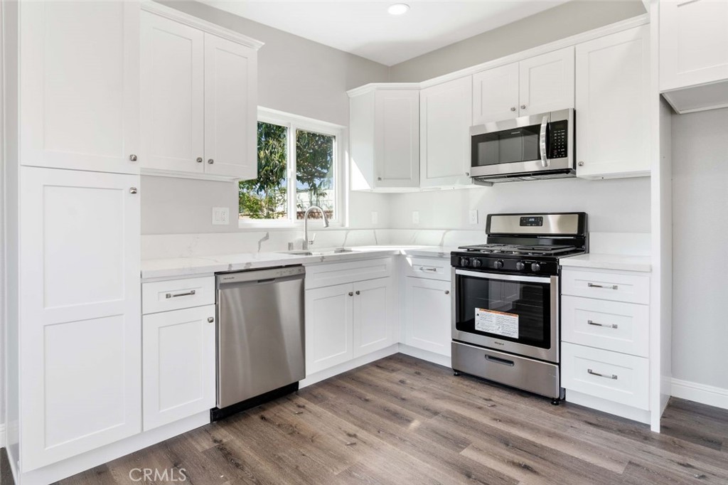 445 Via Val Verde Montebello, CA 90640 - Photo 33 of 51 a kitchen with white cabinets stainless steel appliances and sink