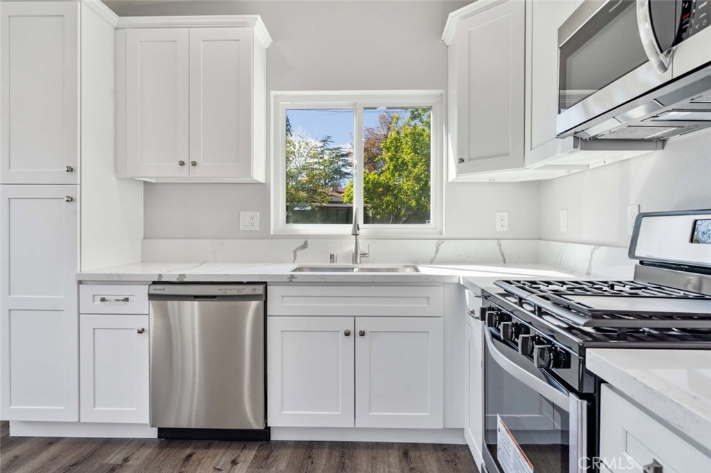 445 Via Val Verde Montebello, CA 90640 - Photo 34 of 51 a kitchen with white cabinets and a stove