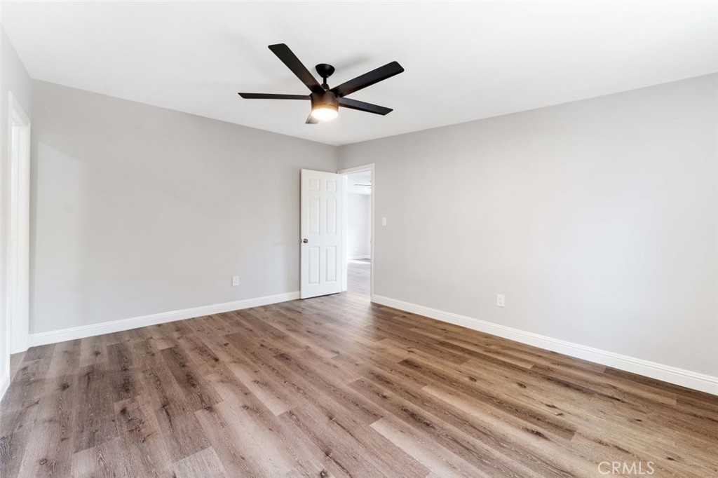 445 Via Val Verde Montebello, CA 90640 - Photo 37 of 51 an empty room with wooden floor ceiling fan and window