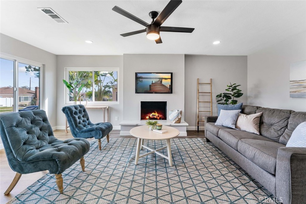 445 Via Val Verde Montebello, CA 90640 - Photo 7 of 51 a living room with furniture a fireplace and a large window