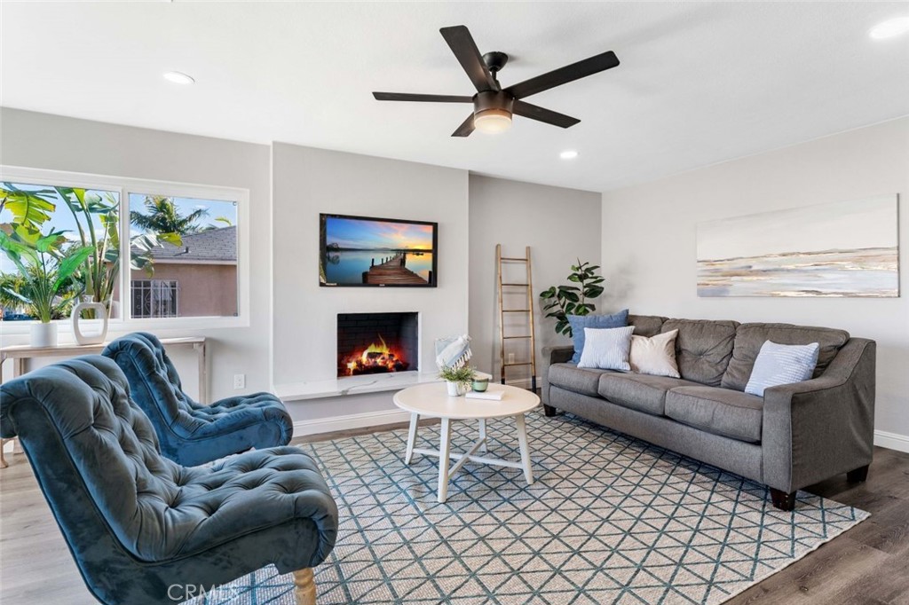 445 Via Val Verde Montebello, CA 90640 - Photo 8 of 51 a living room with furniture a window and a fireplace