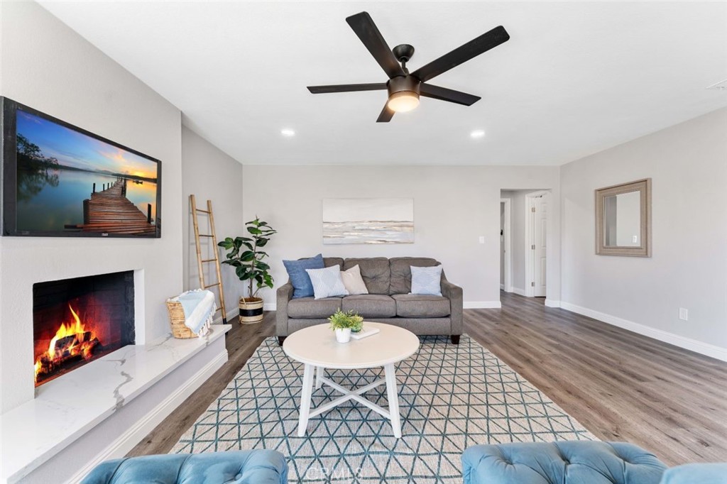 445 Via Val Verde Montebello, CA 90640 - Photo 10 of 51 a living room with furniture a fireplace and a flat screen tv