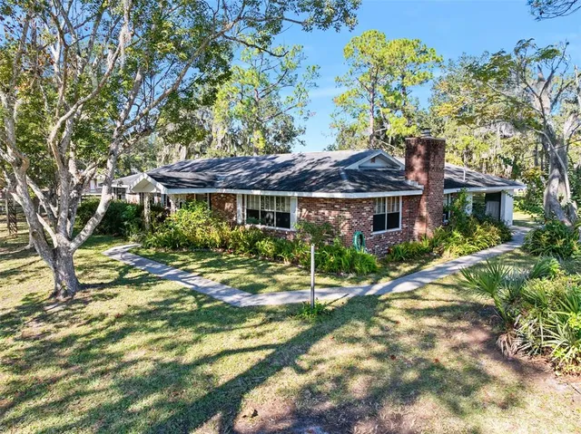 a view of a house with a tree in a yard