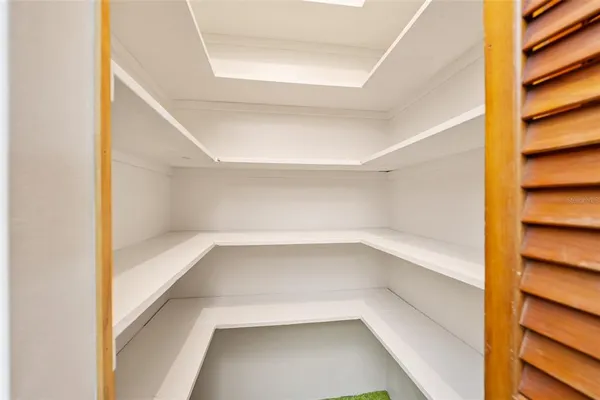 a view of walk in closet with empty racks