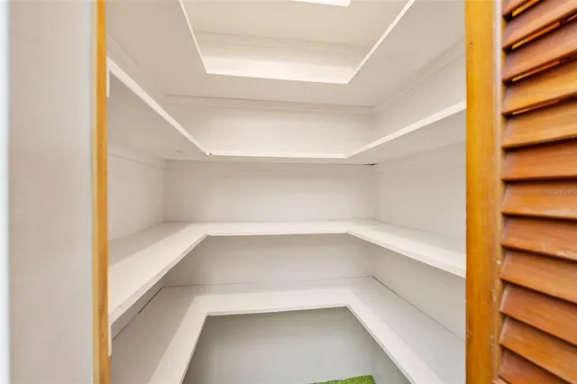 a view of walk in closet with empty racks