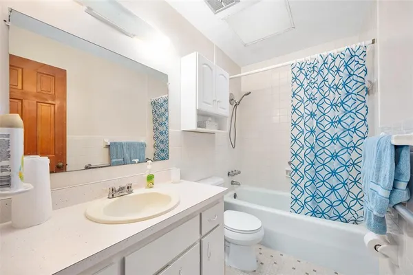 a bathroom with a sink toilet and a mirror