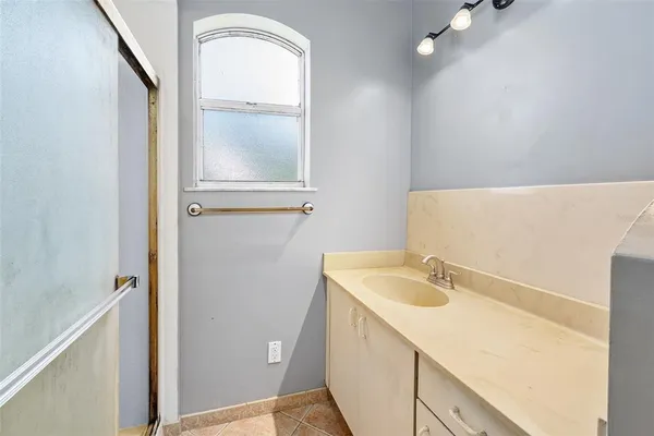 an aerial view of residential house with outdoor space and trees all around