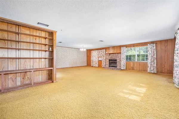 an empty room with furniture and a window