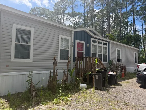 a view of a house with yard porch and furniture