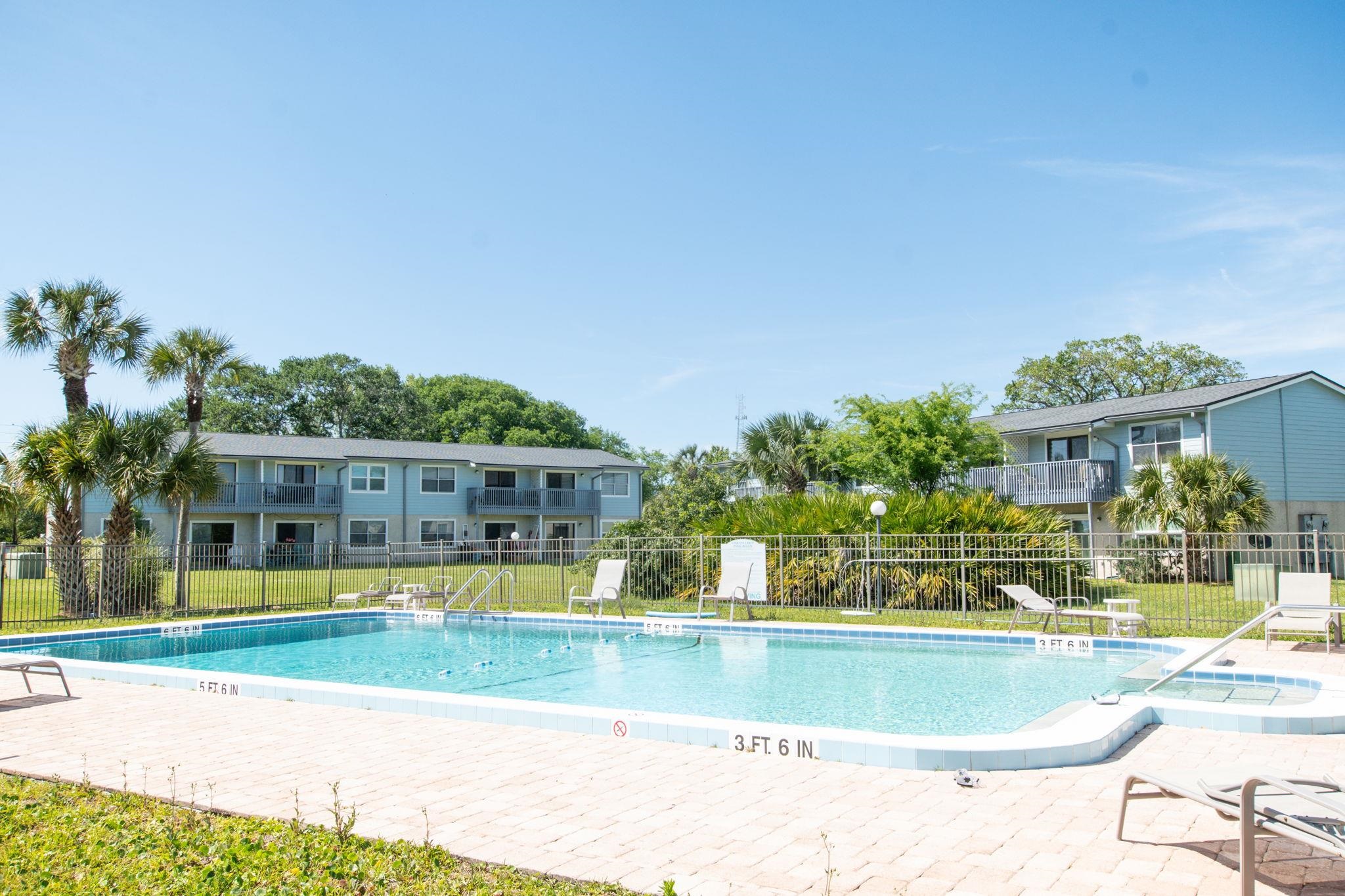 700 West Pope Road, Unit D28 St. Augustine, FL 32080 - Photo 24 of 32 View of swimming pool featuring a lawn