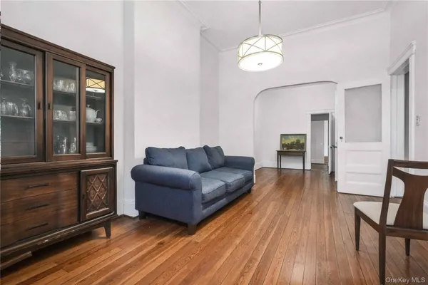 a view of living room filled with furniture and wooden floor