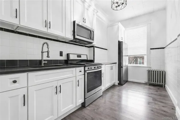 a kitchen with stainless steel appliances a sink and a refrigerator