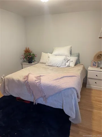 a bedroom with a bed and a night stand