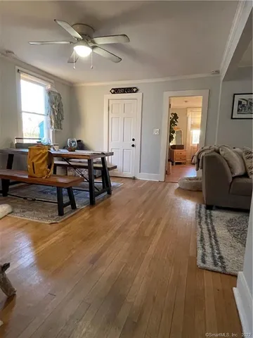 a living room with furniture and a wooden floor