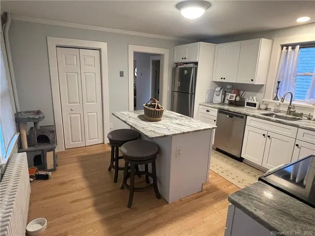 a kitchen with a sink stove and cabinets