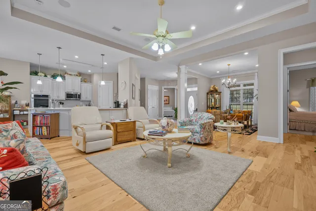 a living room with fireplace furniture and a large window
