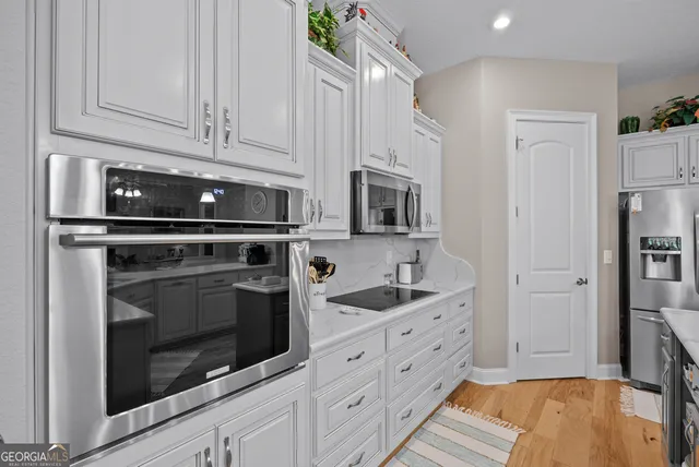 a living room with furniture a large window with wooden floor