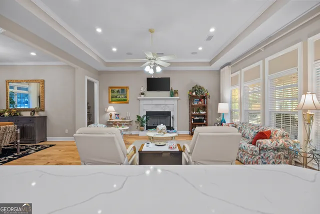 a spacious bedroom with a bed and a chandelier