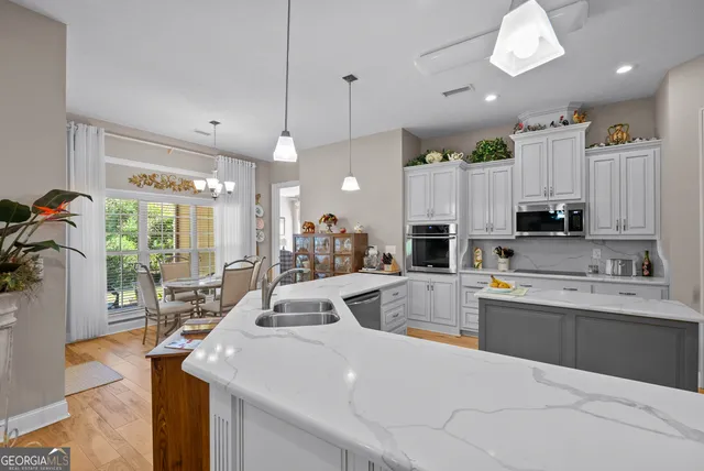 a bathroom with double vanity sink a mirror and a shower