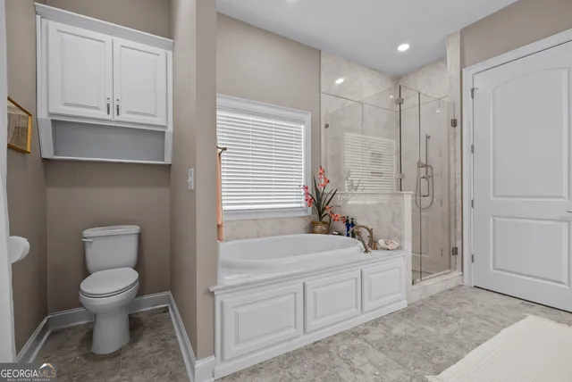 a bathroom with a toilet a sink and bathtub