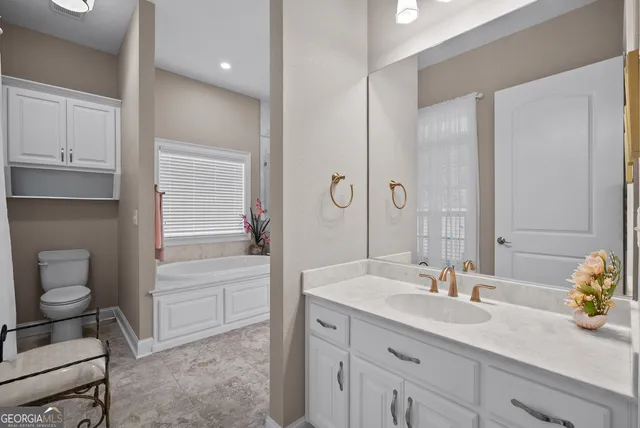 a spacious bathroom with double sink and a mirror