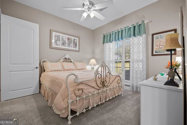 a bedroom with a bed and a chair