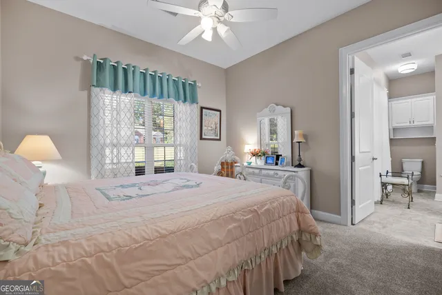 a spacious bedroom with a bed and a dresser