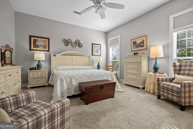 a bathroom with a double vanity sink a mirror and a bathtub