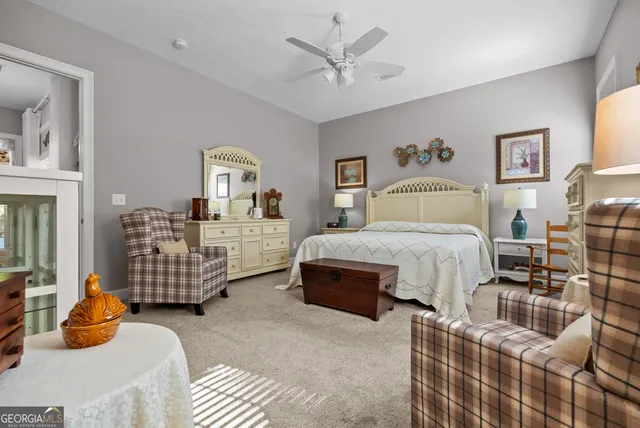 a bathroom with a toilet and a painting on the wall