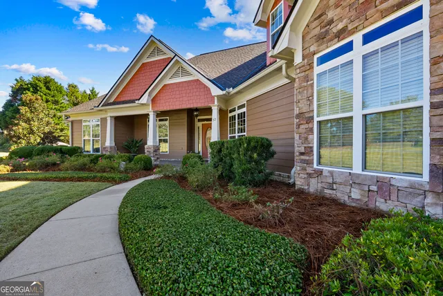 a view of a house with a yard and potted plants