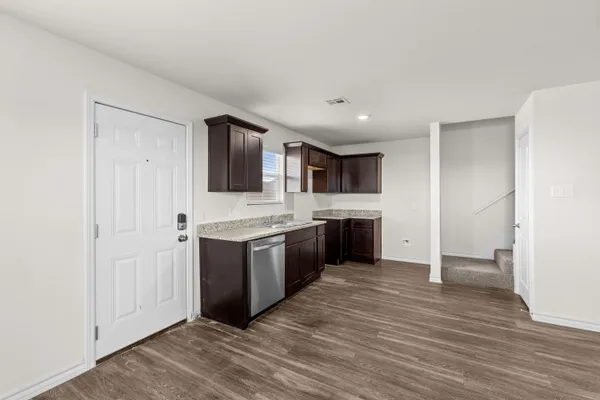 a large kitchen with a stove and a refrigerator