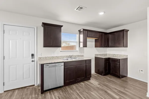 a kitchen with stainless steel appliances granite countertop a stove and a sink