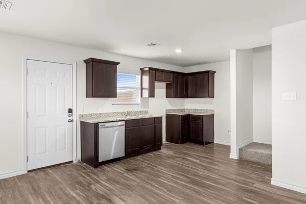 a large kitchen with stainless steel appliances granite countertop a stove and a refrigerator