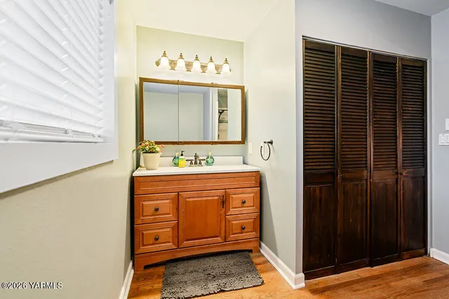 a bedroom with furniture and a flat screen tv