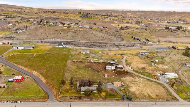 view of a swimming pool with outdoor seating and yard