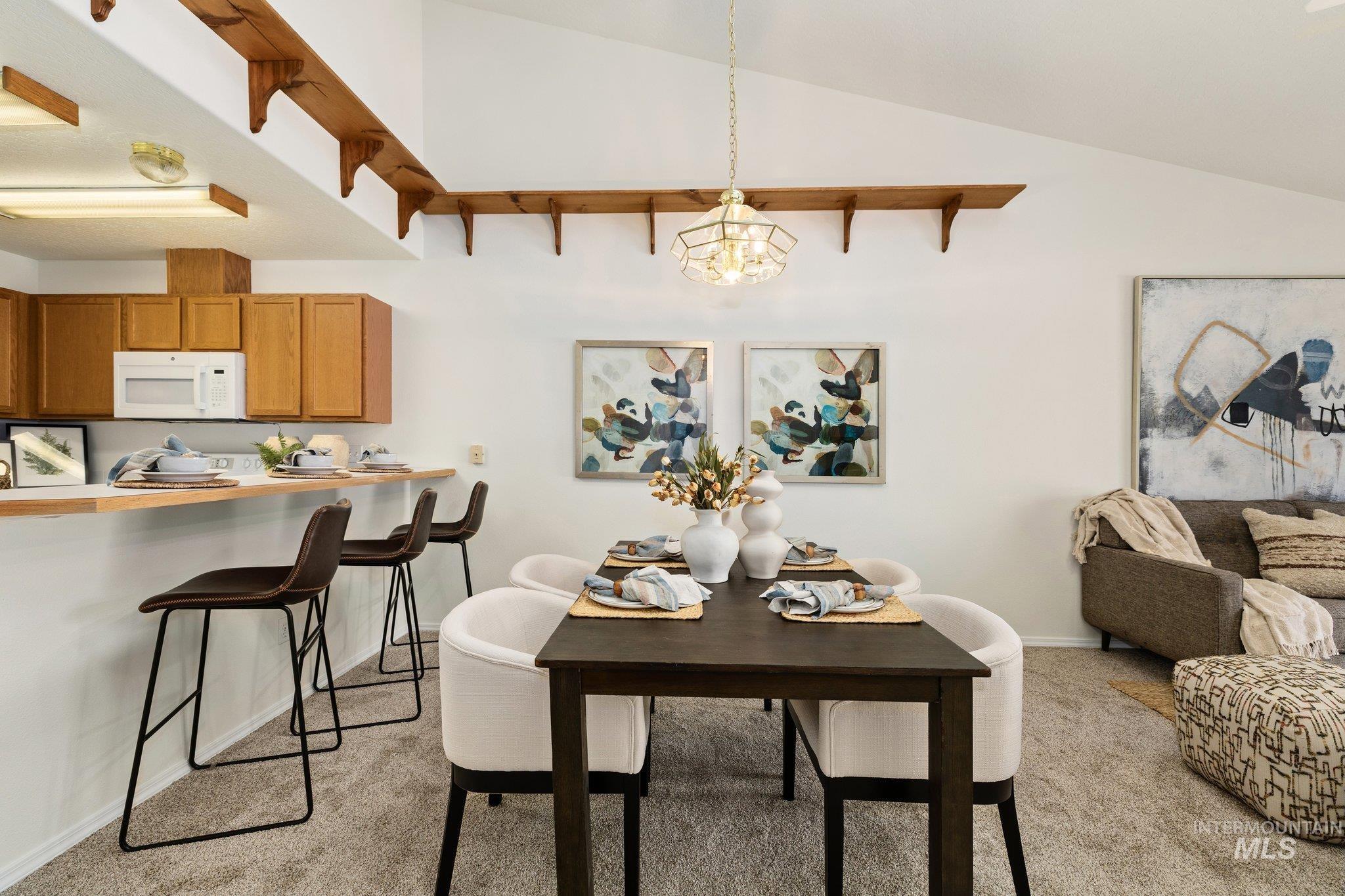 2900 South Ladera Place Boise, ID 83705 - Photo 15 of 31 Dining space featuring light colored carpet, lofted ceiling, and a chandelier