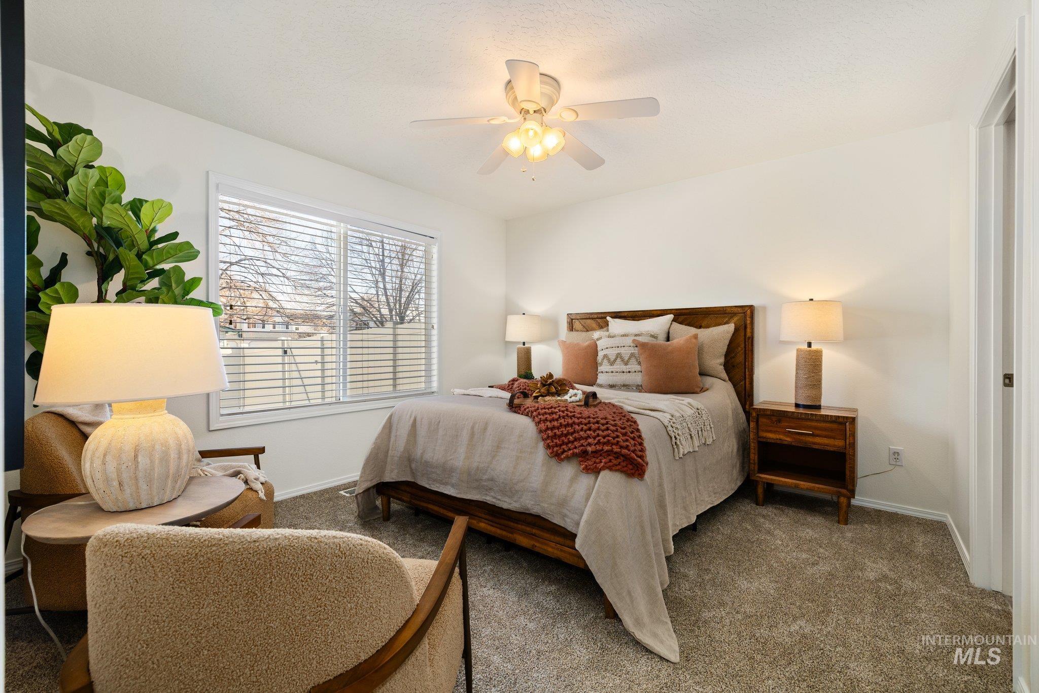 2900 South Ladera Place Boise, ID 83705 - Photo 16 of 31 Bedroom featuring a ceiling fan and carpet floors