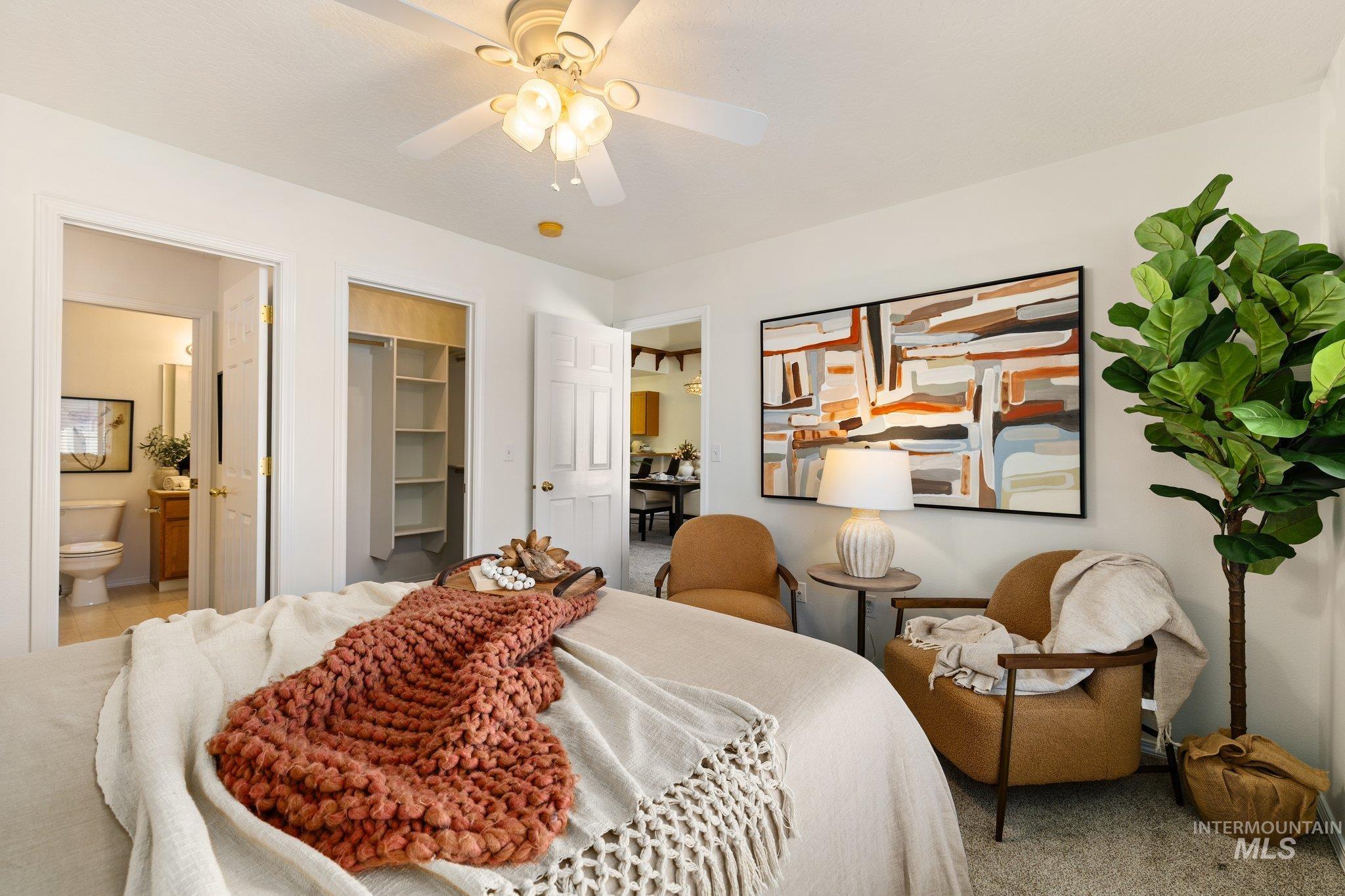 2900 South Ladera Place Boise, ID 83705 - Photo 17 of 31 Bedroom featuring a walk in closet, a ceiling fan, connected bathroom, and carpet floors