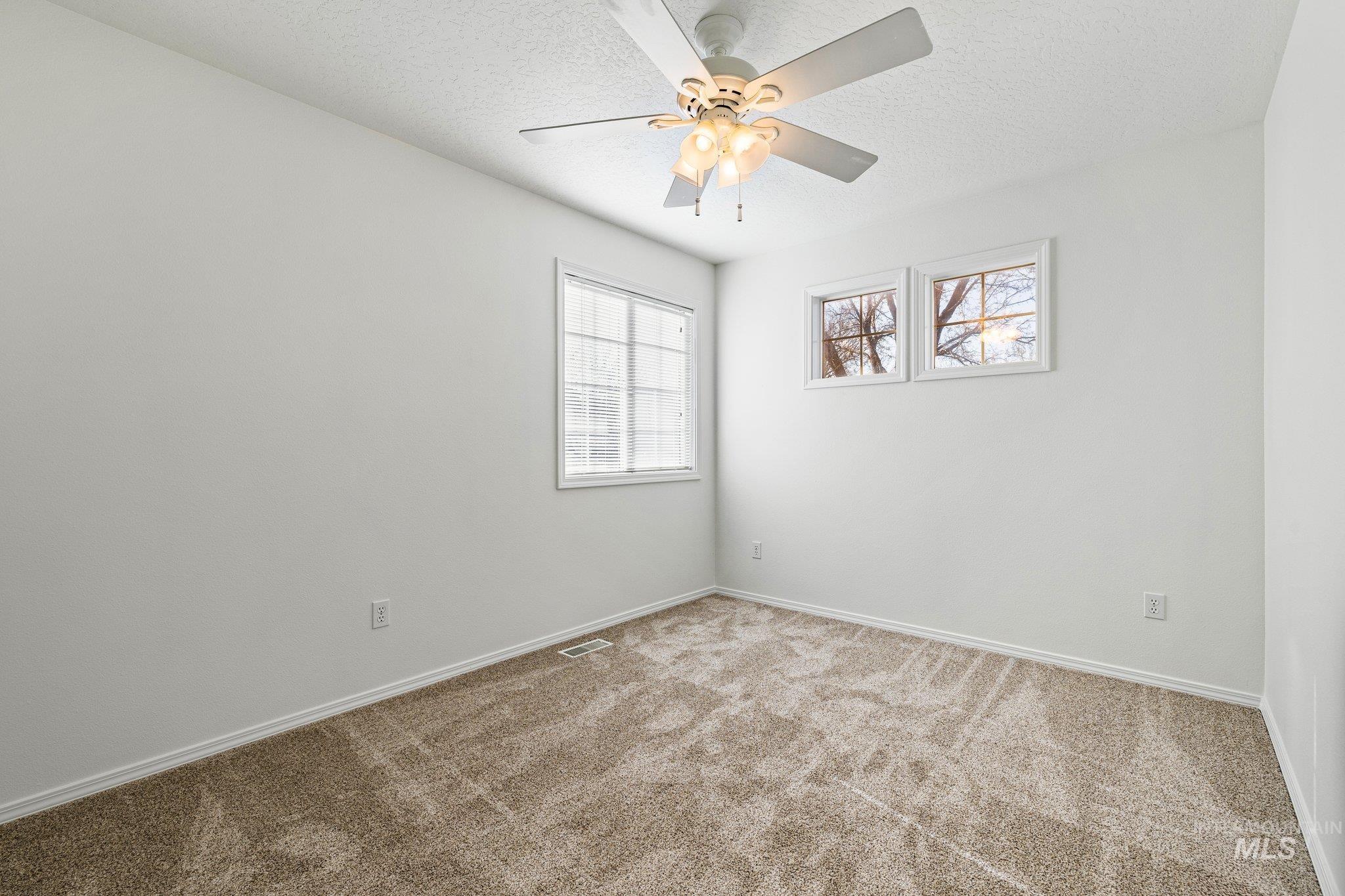 2900 South Ladera Place Boise, ID 83705 - Photo 22 of 31 Spare room featuring carpet floors, a textured ceiling, and ceiling fan