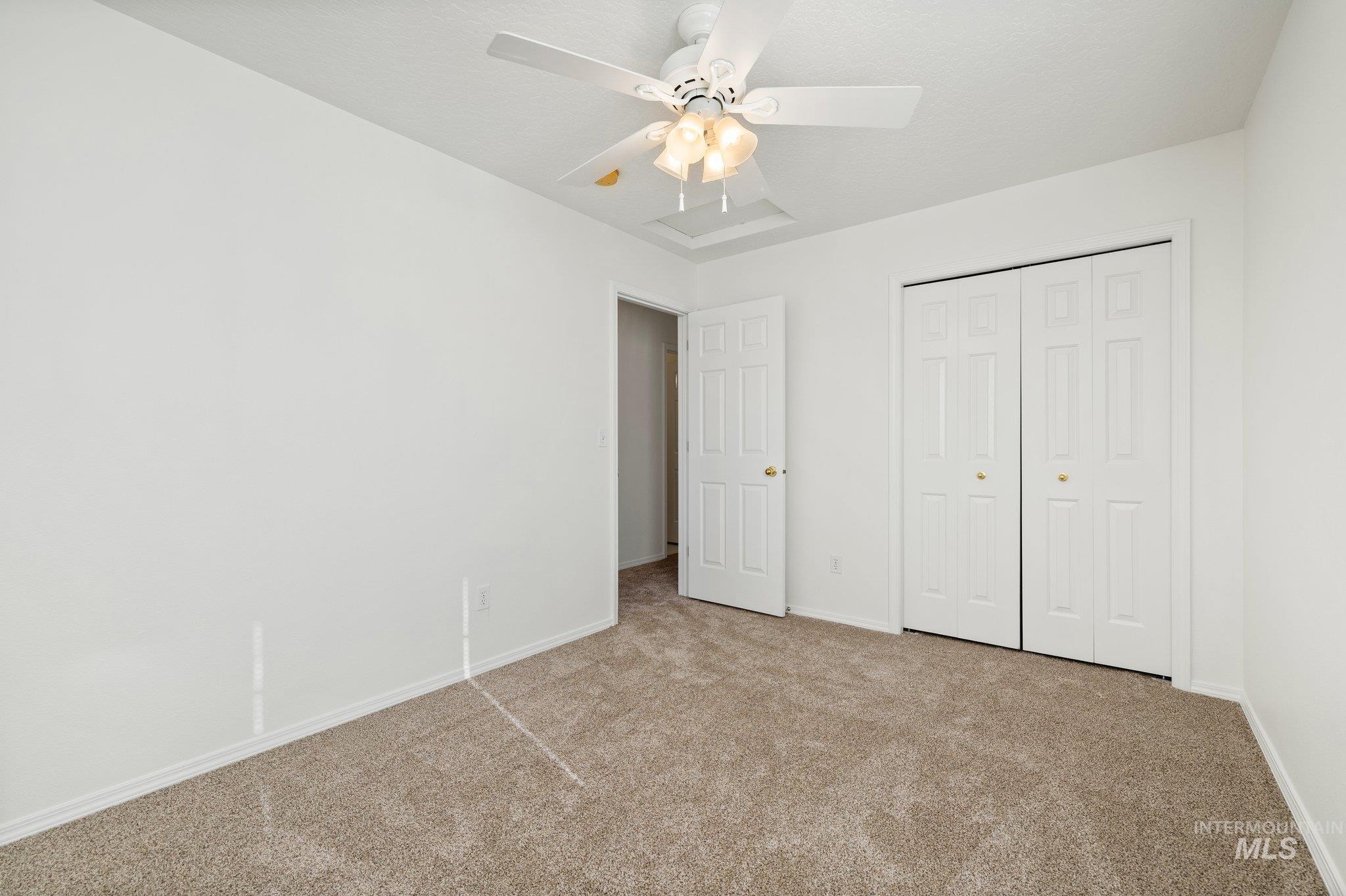 2900 South Ladera Place Boise, ID 83705 - Photo 23 of 31 Unfurnished bedroom featuring carpet floors, a closet, and a ceiling fan