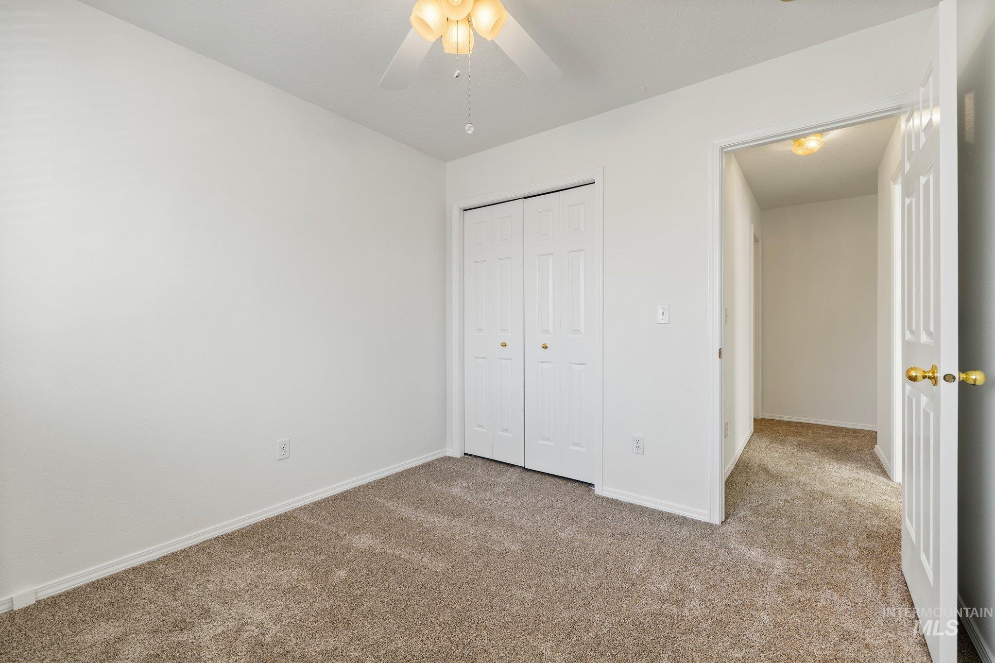 2900 South Ladera Place Boise, ID 83705 - Photo 25 of 31 Unfurnished bedroom featuring carpet flooring, a closet, and a ceiling fan