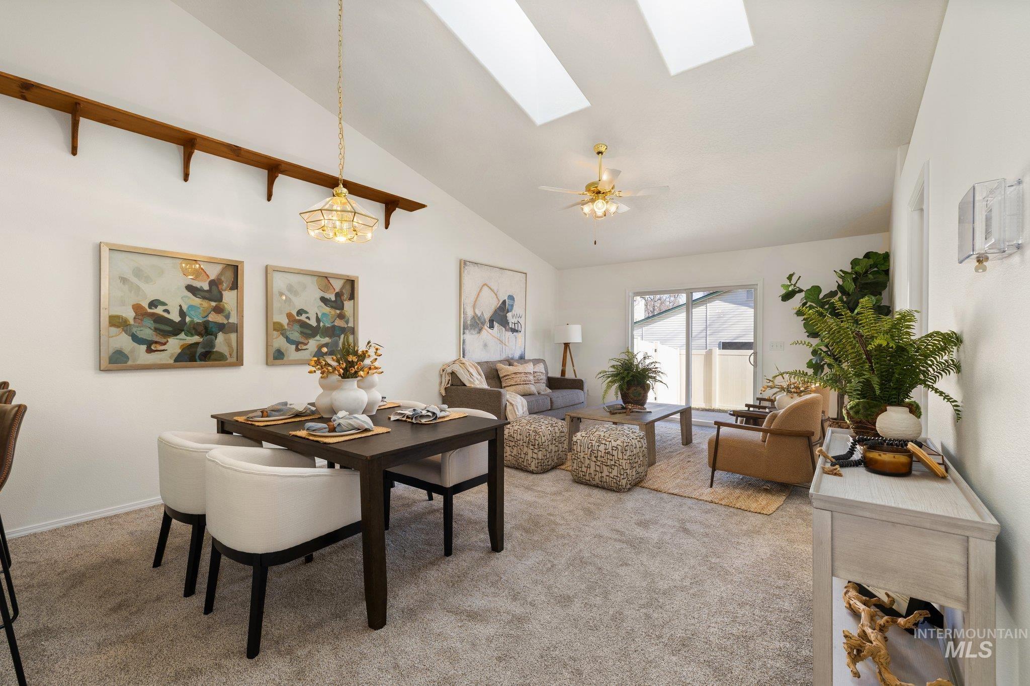 2900 South Ladera Place Boise, ID 83705 - Photo 6 of 31 Dining area with light carpet, a skylight, ceiling fan, high vaulted ceiling, and a chandelier