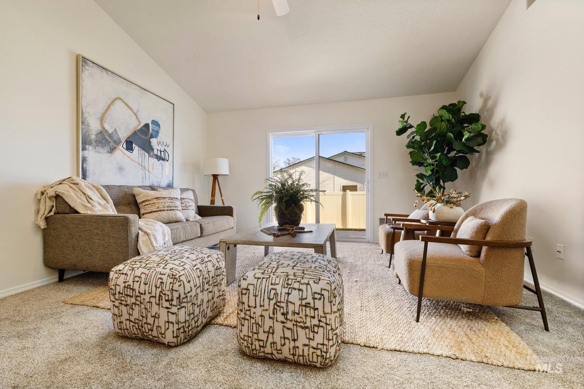 2900 South Ladera Place Boise, ID 83705 - Photo 8 of 31 Living area featuring vaulted ceiling, light colored carpet, and ceiling fan