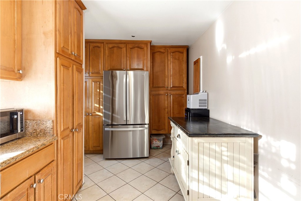 10731 Wright Road South Gate, CA 90280 - Photo 11 of 35 a kitchen with granite countertop a refrigerator and a sink