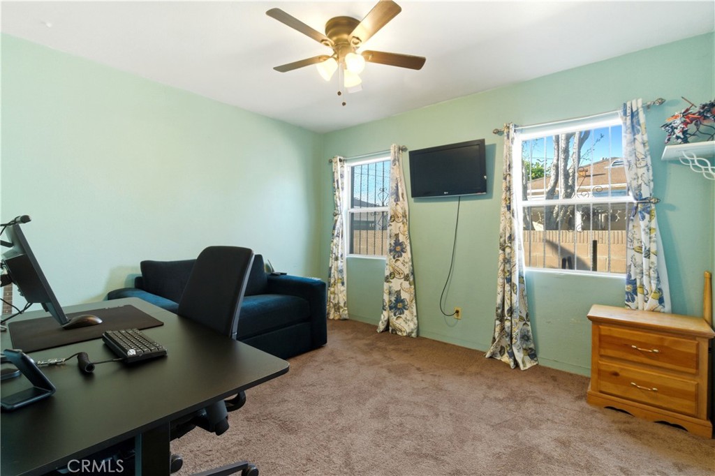 10731 Wright Road South Gate, CA 90280 - Photo 15 of 35 a living room with furniture and a flat screen tv