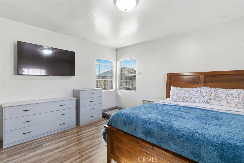 10731 Wright Road South Gate, CA 90280 - Photo 17 of 35 a bedroom with a large bed and a flat screen tv