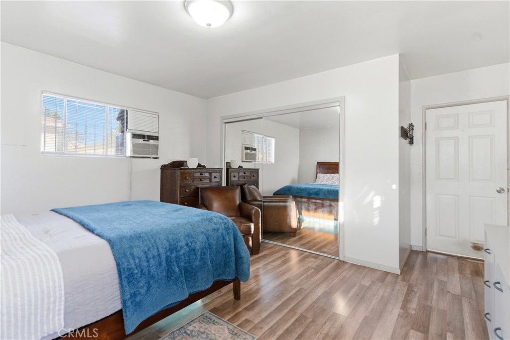 10731 Wright Road South Gate, CA 90280 - Photo 19 of 35 a bedroom with a bed and wooden floor