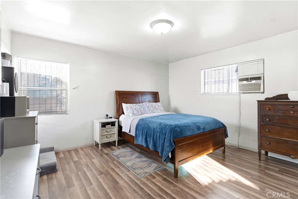 10731 Wright Road South Gate, CA 90280 - Photo 20 of 35 a bedroom with a bed and wooden floor