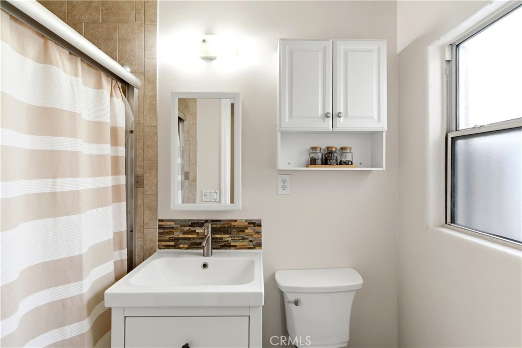 10731 Wright Road South Gate, CA 90280 - Photo 21 of 35 a bathroom with a sink a toilet and shower