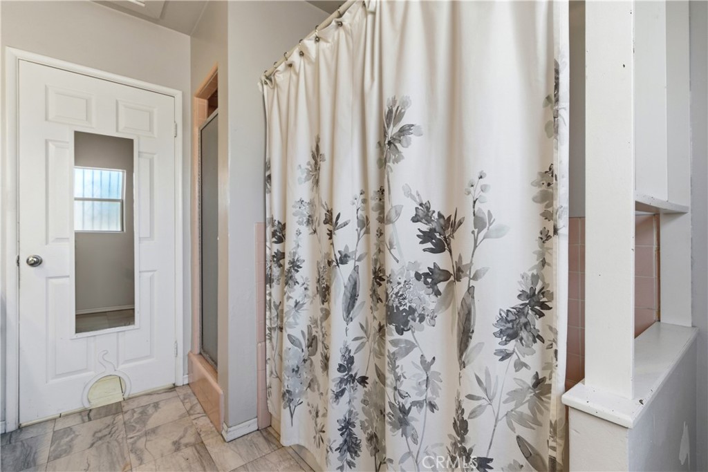 10731 Wright Road South Gate, CA 90280 - Photo 24 of 35 a view of a bathroom with a shower and a mirror